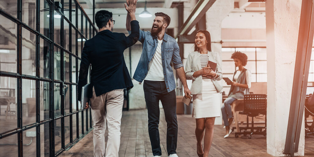 High-five!,Full,Length,Of,Two,Cheerful,Young,Business,People,Giving