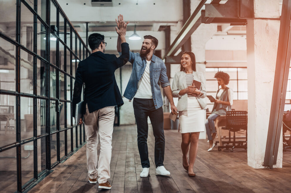 High-five!,Full,Length,Of,Two,Cheerful,Young,Business,People,Giving