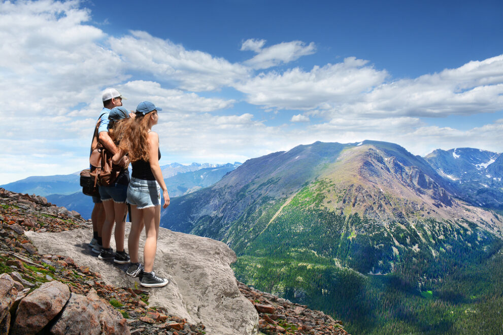 Father,With,Arms,Around,His,Family,Looking,At,Summer,Mountains