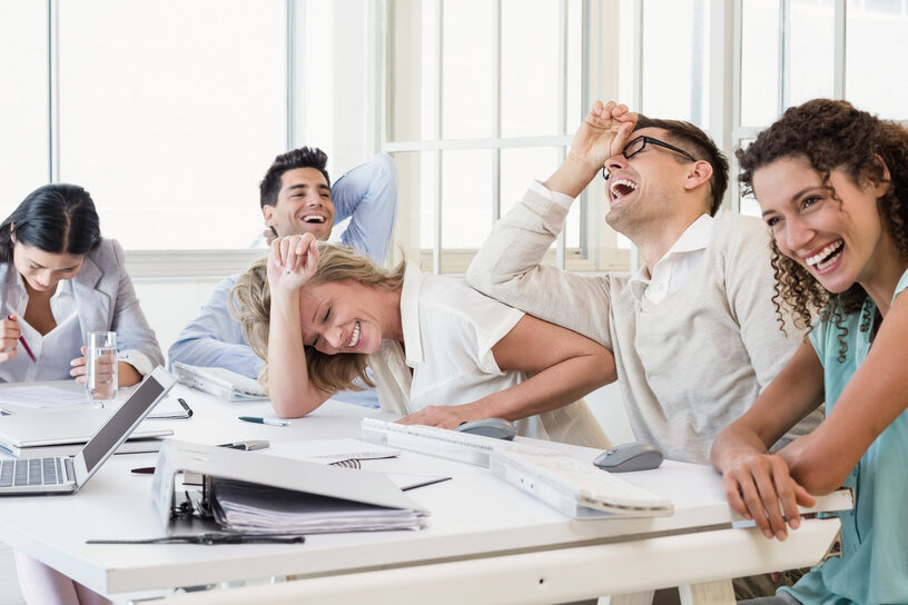 Casual,Business,Team,Laughing,During,Meeting,In,The,Office