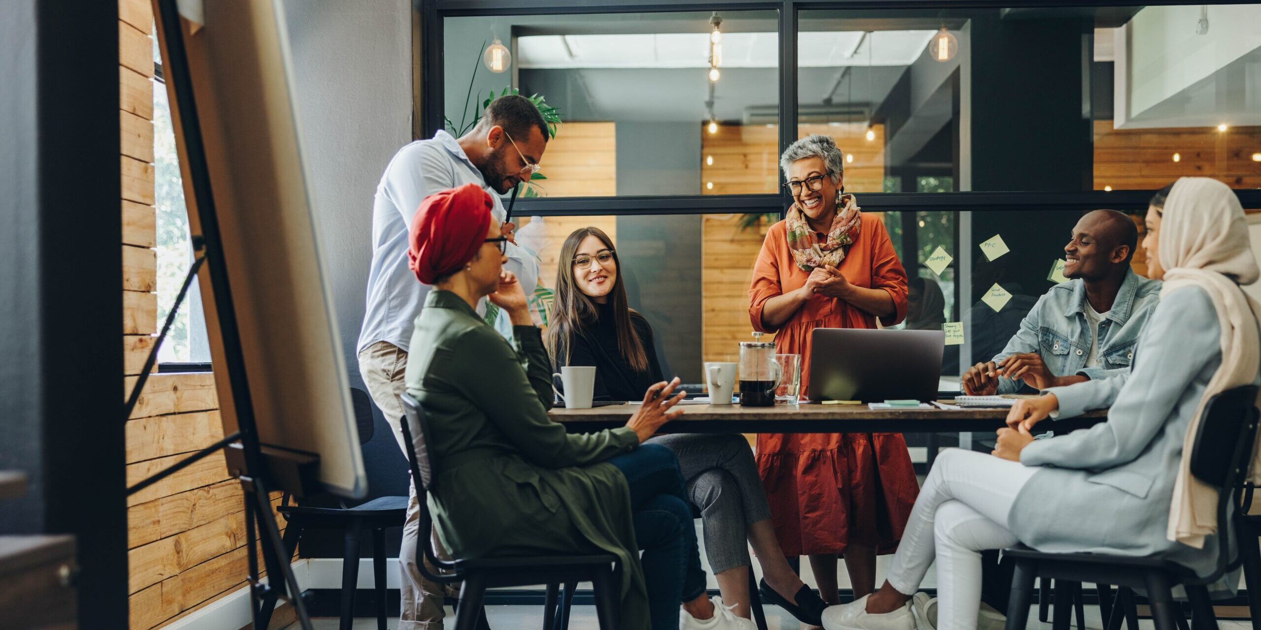 Happy,Businesspeople,Smiling,Cheerfully,During,A,Meeting,In,A,Creative Conference room