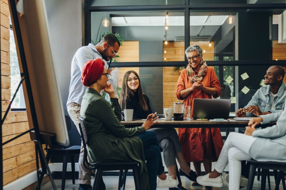 Happy,Businesspeople,Smiling,Cheerfully,During,A,Meeting,In,A,Creative Conference room